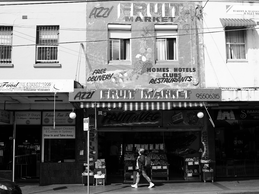 A passer-by outside Mr Azzi's fruit shop, Enmore Road.